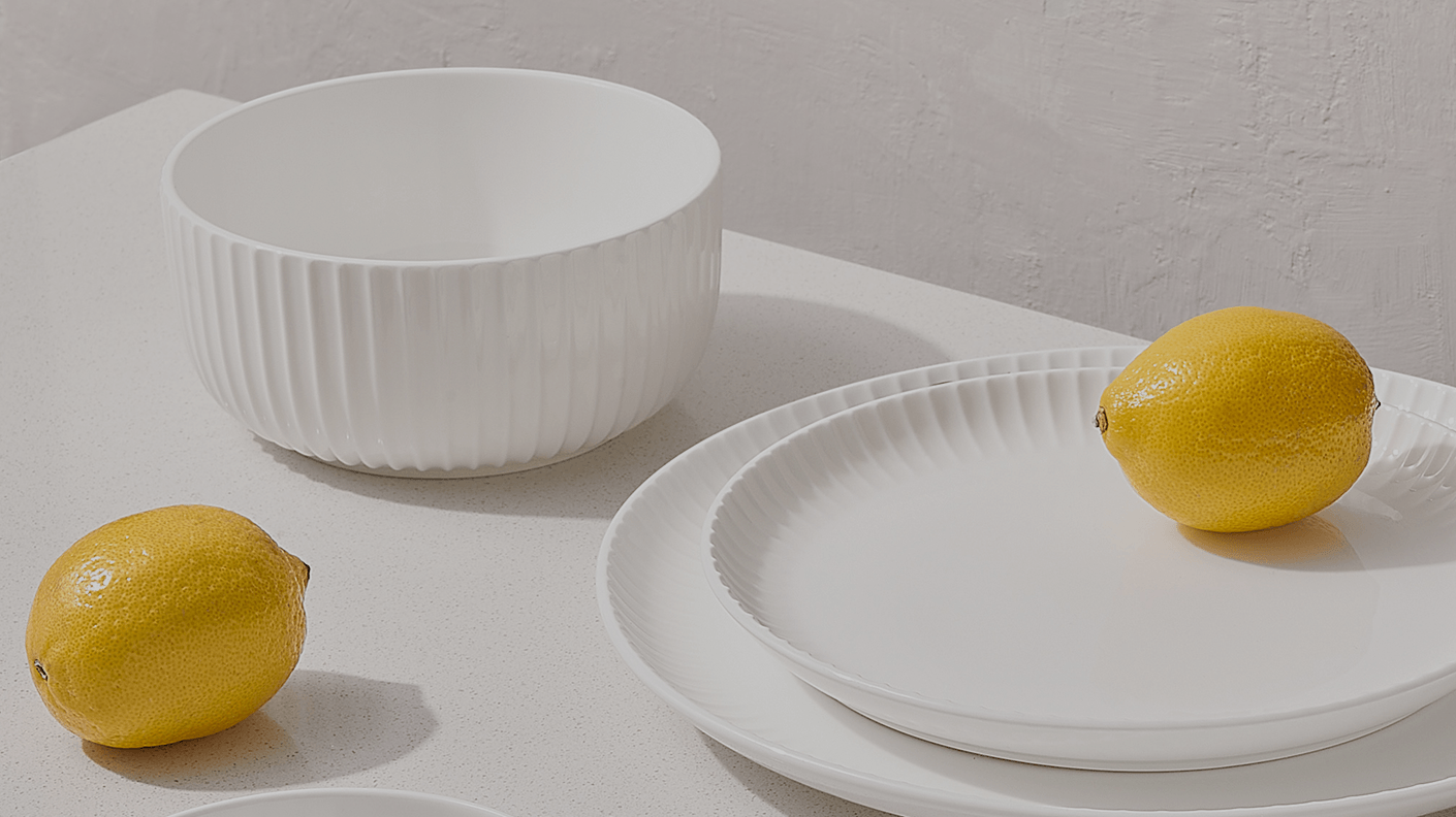 A simple white table with a smooth surface, set against a neutral background.